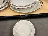 three plates and a bowl sitting on a table
