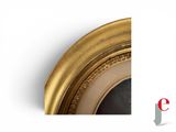 an image of a picture of a gold oval mirror with a white background