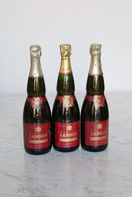 three bottles of wine sitting on top of a marble counter top