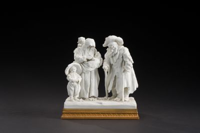 a white figurine of three people standing on a wooden base