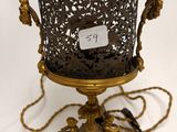 a gold vase on a white pedestal with a tag on it