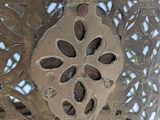 a metal vase that has a flower design on it