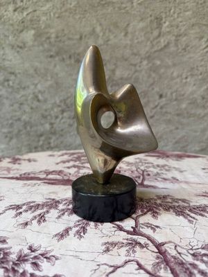 bronze sculpture of a bird ' s head on a marble base