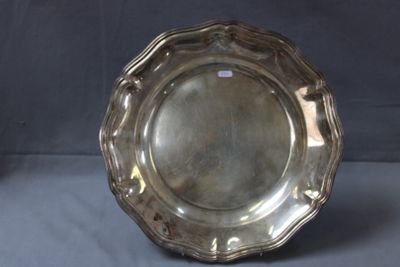 assiette en argent avec un bord festonné sur fond gris