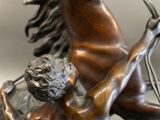 a bronze statue of a man riding a horse