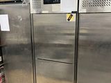 stainless steel refrigerators in a commercial kitchen with shelves and shelves
