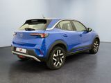 the rear view of a blue car in a showroom