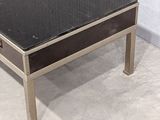 a coffee table with a black top on a white floor
