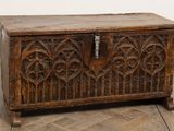 an old wooden chest sitting on top of a wooden floor next to a wall
