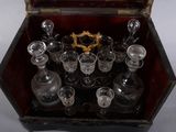 a wooden box with a glass set inside of it