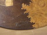 a close up of a piece of wood with a clock on it