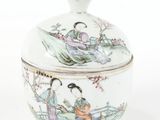 a white bowl with a lid that has a painting on it