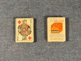 two small playing cards sitting next to each other on a table