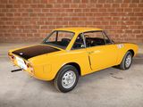 an old yellow car is parked in front of a brick wall