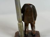 a figurine of a man with a gun on a table