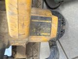 a close up of a person ' s feet and a drill