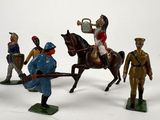 several figurines of men in uniforms on a white surface