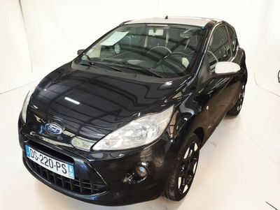 a black car that is parked in a white room