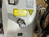 a white machine with a yellow sticker on it