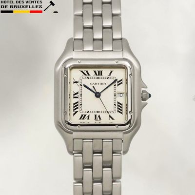 a close up of a wrist watch with roman numerals on it