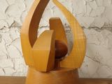 a wooden sculpture that is on a wooden shelf