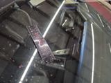 a remote control sitting on the windshield of a car
