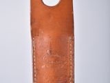 a brown leather case on top of a metal pole