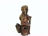 a small statue of a man sitting on a chair