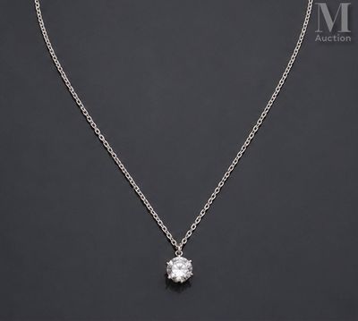 a white diamond pendant on a silver chain on a black background