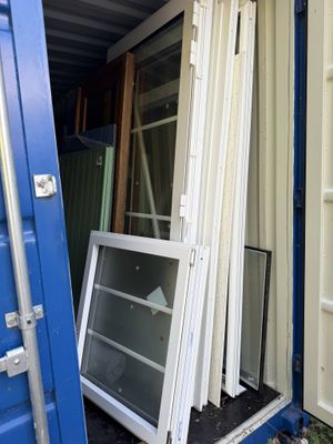a blue shipping container that has a window and a window pane in it