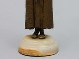 a statue of a man in a robe holding a book