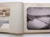 an open book with a picture of a river and a bridge