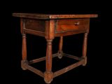 a small wooden table with a drawer on it