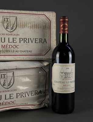 a bottle of red wine next to a box of cheese
