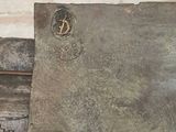 a large piece of metal sitting on top of a wooden bench