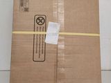 a box with a yellow ribbon wrapped around it sitting on top of a table