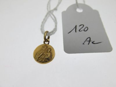 a close up of a gold coin with a tag attached to it