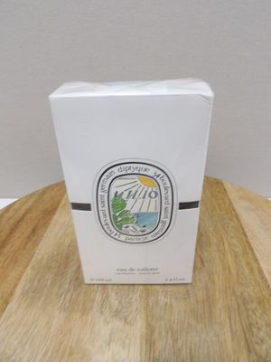 a white box on a wooden table with a logo on it