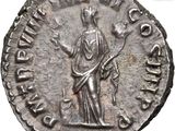 a close up of a coin with a statue on top of it