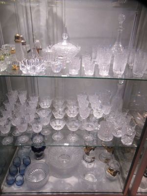 a glass display case with a lot of glasses on it