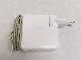 an apple power adapter plugged into a charger on a table