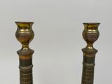two candles that are sitting on a table