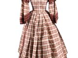 the back of a dress with a plaid pattern on it