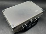 a close up of a briefcase on a table with a black background