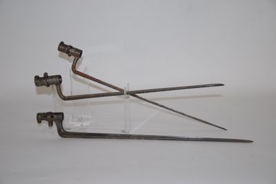 two metal tools that are sitting on a white surface