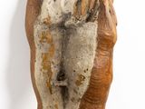 an image of a wooden sculpture of a person with a hat on