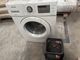 an image of a washing machine and other appliances in a warehouse