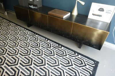 a black and white rug on the floor in a room