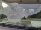 a picture of a car windshield with a sign on it