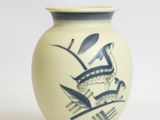 a white vase with a blue design on it